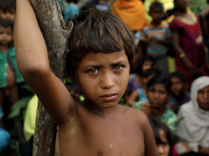 A Rohingya refugee girl looks next to newly arrived refugees who fled to Bangladesh from Myanmar in Ukhiya on September 6, 2017. /AFP
