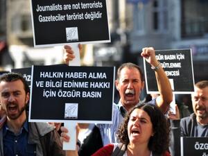 A file photo shows demonstrators protesting against freedom of speech infringements and journalists' arrests in Turkey last November. Sunday's raid attempt was only the most recent in a list of trouble journalists have faced with the Turkish government. (AFP/File)