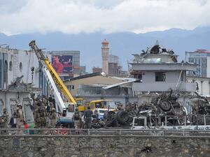 Afghan forces gather at the site of a car bomb in Kabul on April 19. (AFP/Shah Marai)