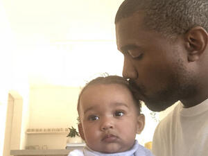 Aww: Kanye West showed his softer side as he took to Twitter on Monday to share an adorable photo of himself kissing seven-month-old daughter Chicago on the head (Source: Kanye West - Twitter)