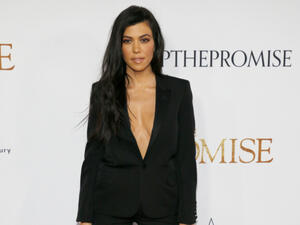 When Kourtney was posing for a mirror selfie with Khloe and Kim, they pretty much ignored her (Source: Tinseltown - Shutterstock)