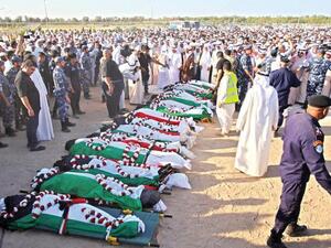 Mourners pray over the bodies of the victims of the al-Imam al-Sadeq mosque bombing in Kuwait City on June 27, 2015. (AFP/File)