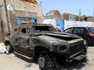 The wreckage of burnt vehicles and ransacked buildings are seen the day after deadly clashes at the Abu Salim police station on June 27, 2013 in Tripoli (Mahmud Turkia / AFP)