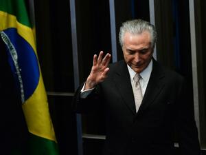 President Michel Temer waves as he takes office before the plenary of the Brazilian Senate in Brasilia, on August 31, 2016. (AFP/Andressa Anholete)