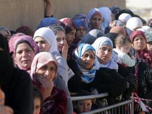 Syrian women wait in Arsal, Lebanon. (AFP/File) Syrian women wait in Arsal, Lebanon. (AFP/File)