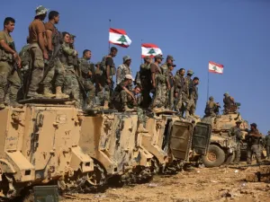 Lebanese soldiers stand on armoured vehicles. (AFP/ PATRICK BAZ)
