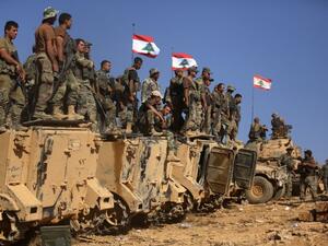 Lebanese soldiers stand on armoured vehicles. (AFP/ PATRICK BAZ)