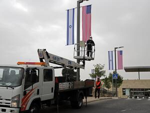 A worker installs decorations of Israeli and US flags in front of the US Consulate in Jerusalem where US officials will install the new US Embassy/ AFP A worker installs decorations of Israeli and US flags in front of the US Consulate in Jerusalem where US officials will install the new US Embassy/ AFP