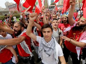 Supporters of the Lebanese Communist party take part in an International Workers' Day rally in Beirut (ANWAR AMRO/AFP)