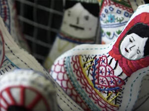 The women who make the dolls hope that giving the dolls a personal story will help people see the individuals struggling through Syria's war. (YouTube/Euronews)