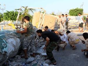 Members of Libyan pro-government forces hold a position as they fight to clear DAesh from its main Libyan stronghold of Sirte on August 13, 2016 in Sirte. (AFP/Mahmud Turkia)