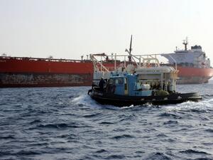 A general view shows a tug boat sailing near the Malta-flageed Seadelta oil tanker off the coast of Libya's eastern Ras Lanuf port on September 19, 2016. (AFP/Stringer)