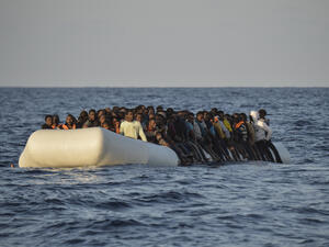 Migrants and refugees on a rubber boat before to be rescued by the ship Topaz Responder run by Maltese NGO Moas and the Red Cross, off the Libyan coast in the Mediterranean Sea, on November 3, 2016. (AFP/Andreas Solaro)