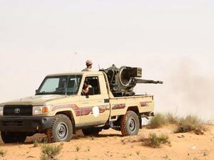 Fighters from the Libya Dawn militia fire at positions of forces loyal to Libya's internationally recognized government. (AFP/ File)