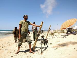Members of the self-styled Libyan National Army, loyal to the country's east strongman Khalifa Haftar, fire mortar shells during clashes with militants in Benghazi's central Akhribish district on July 19, 2017 (AFP)