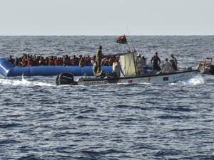 This file photo taken on November 04, 2016 shows migrants and refugees on a rubber boat as the Libyan coastguards patrol on November 4, 2016 off the Libyan coast. (Andreas Solaro/AFP)