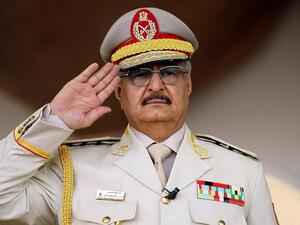 Khalifa Haftar salutes during a military parade in the eastern city of Benghazi. (AFP/ File)
