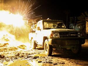 A member of the Libyan National Army (LNA) fires a machine gun mounted on the back of a Toyota pickup truck against jihadists in district of Suq al-Hut in the eastern coastal city of Benghazi, on March 26, 2017. (AFP/Abdullah Doma)