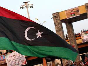 The new Libyan flag is raised during a parade in the eastern city of Benghazi to celebrate the second anniversary of Nato's first military operation in Libya. (AFP/ File)