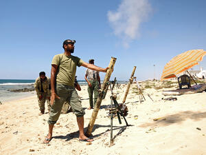 Members of the self-styled Libyan National Army, loyal to the country's east strongman Khalifa Haftar, fire mortar shells during clashes with militants in Benghazi. (AFP) 