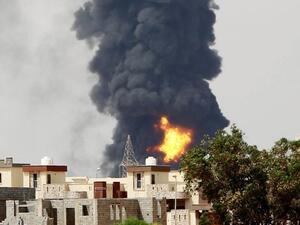 Column of smoke billowing over Tripoli, Libya. (AFP/File)

