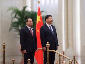 China's President Xi Jinping (R) and his Egyptian counterpart Abdel Fattah al-Sisi listen to anthems during a welcome ceremony at the Great Hall of the People on September 1, 2018. 
Nicolas ASFOURI / AFP