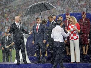 The Croatian and French presidents while getting drenched in the heavy rain during the World Cup final ceremony while Russia's Putin is the only one to get an umbrella. (Twitter)