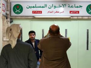 Jordanians check the main entrance of the Muslim Brotherhood's office in Amman. (AFP/File)