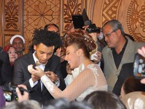 Mai Kassab and Oka celebrating holy matrimony.