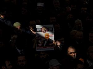A person holds a banner of Jamal Khashoggi during a symbolic funeral prayer for the Saudi journalist, killed and dismembered in the Saudi consulate in Istanbul in October. (AFP)
