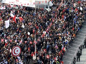 Tunisian protesters wave national flags .(FETHI BELAID / AFP)