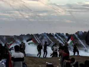 Palestinians react to tear gas fired by Israeli forces during a protest on November 23, 2018 in Gaza. (MAHMUD HAMS / AFP)