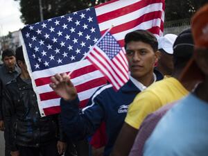 Central American migrants -mostly Hondurans- wanting to reach the United States in hope of a better life, queue for food outside a shelter in Tijuana, Baja California State, Mexico. (AFP)
