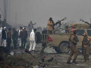 Afghan security forces and investigators gather at the site of a suicide bomb attack outside a British security firm's compound in Kabul, a day after the blast on November 29, 2018. (NOORULLAH SHIRZADA / AFP)