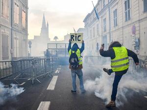 Protesters face riot police on January 5, 2019 in La Rochelle during a demonstration called by the yellow vests (gilets jaunes) movement. (AFP)