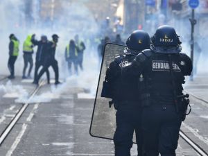 French gendarmes of the CIOP (cellule image ordre public) face protestors during an anti-government demonstration called by the yellow vest "Gilets Jaunes" movement. (AFP)