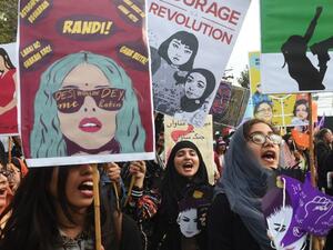 Pakistani civil society activists carry placards and shout slogans during a rally for women rights on International Women's Day in Lahore on March 8, 2019. (ARIF ALI / AFP)