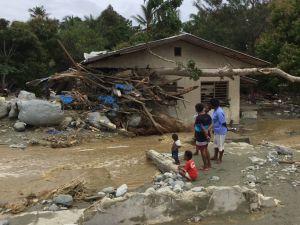 Tree trunks and debris washed away by flash floods are seen lodged in a damaged house in Sentani near the provincial capital of Jayapura, Indonesia. (AFP)