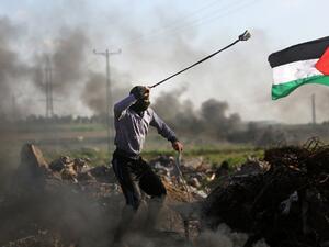 Palestinian protesters hurls a rock at Israeli security forces during clashes near the Shejaiya area of Gaza City . (AFP/ File)