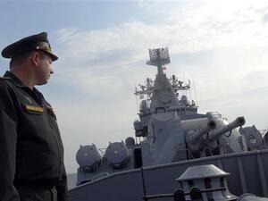 Russian Navy Captain Alexander Shvarts stands in front of an artillery system on the Russian missile cruiser Moskva as it patrols in the Mediterranean Sea. (AFP/File)