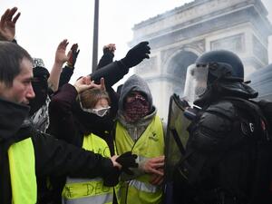 Riot police face demonstrators during a "Yellow vest" protest in Paris on December 1. (AFP/FILE)