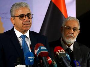 Libyan Foreign Minister Mohamed Taher Siala (R) and Interior Minister Fathi Bash Agha (L) deliver a speech following an attack on the Foreign ministry. (AFP)