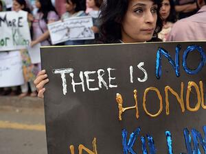 Human rights activists at a protest in Islamabad with sign reads " there is no honor in killing'. (AFP/File)