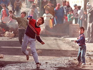 Palestinians throw stones in Ramallah as part of the 1st 1987 Intifada. (AFP) Palestinians throw stones in Ramallah as part of the 1st 1987 Intifada. (AFP)
