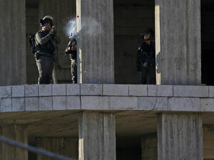 An Israeli soldier fires a tear gas canister at Palestinian stone throwers following a raid in Ramallah. (AFP/ File)