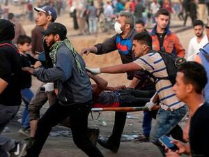 Palestinians evacuate an injured protestor during clashes near the Israeli border fence in Gaza.(AFP/ File Photo)