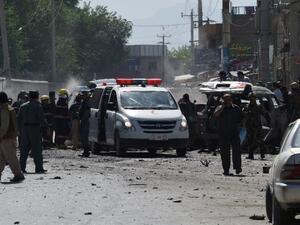 Afghan security forces inspect the site of a suicide attack near Kabul airport. (AFP Photo/Shah Marai)