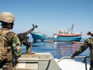 Libyan coastguards stand on an armoured boat as they patrol the sea off Libya's western coast. (AFP/File)