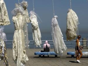 Lebanese activists use an installation of wedding dresses by Lebanese artist Mireille Honein at Beirut's Corniche to protest rape laws. (AFP)