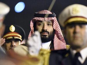 Crown Prince Mohammed bin Salman is seen behind a military band upon his arrival at Algiers International Airport on Dec. 2, 2018. (AFP / RYAD KRAMDI)